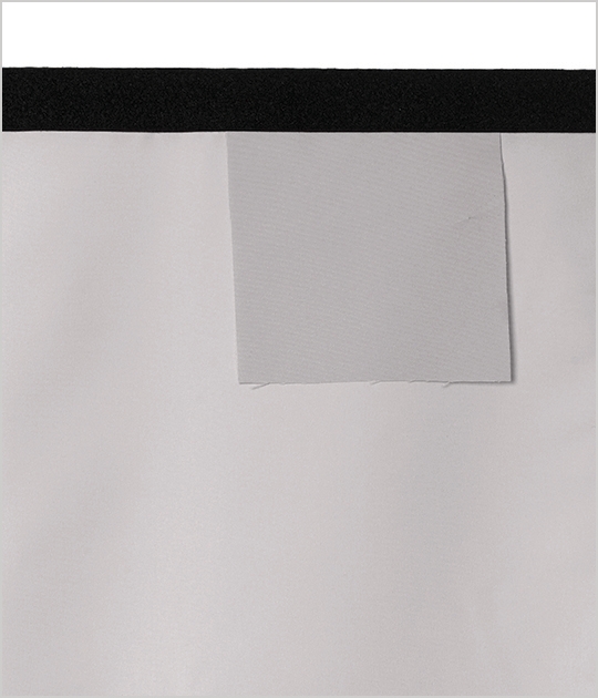 A curtain with a burn sample