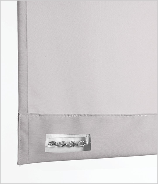 The bottom of a curtain with a chain hem