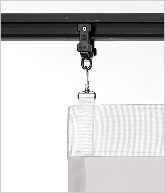 A curtain attached to a track system with clip and webbing.