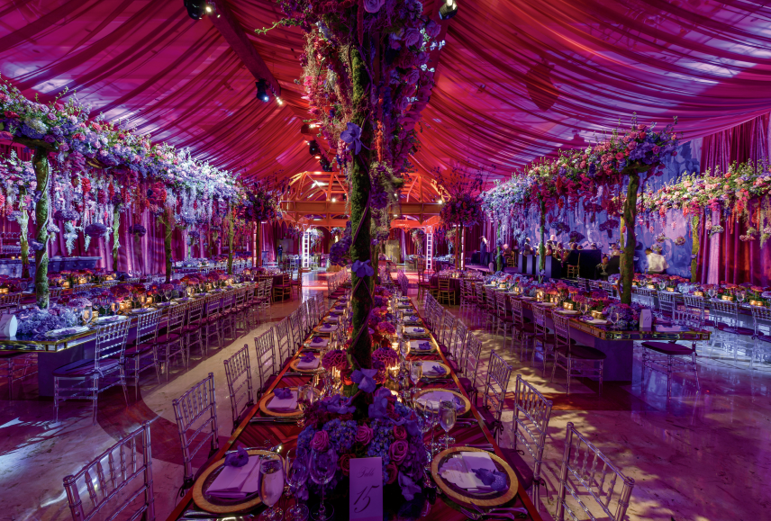 Blue-lit theatrical drapery installation in a large event venue